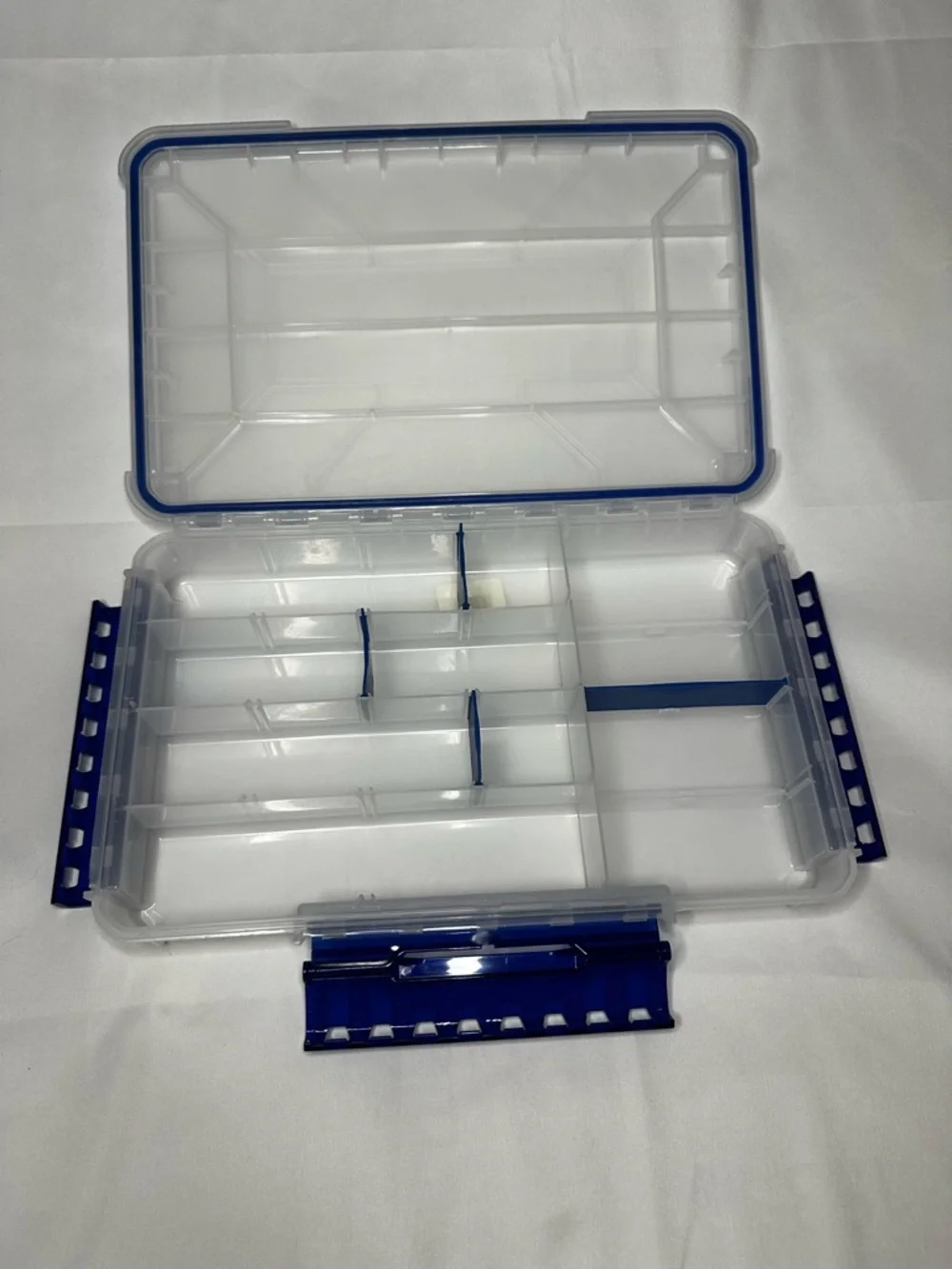 Multi-Compartment Clear Plastic Storage Box with Blue Accents.